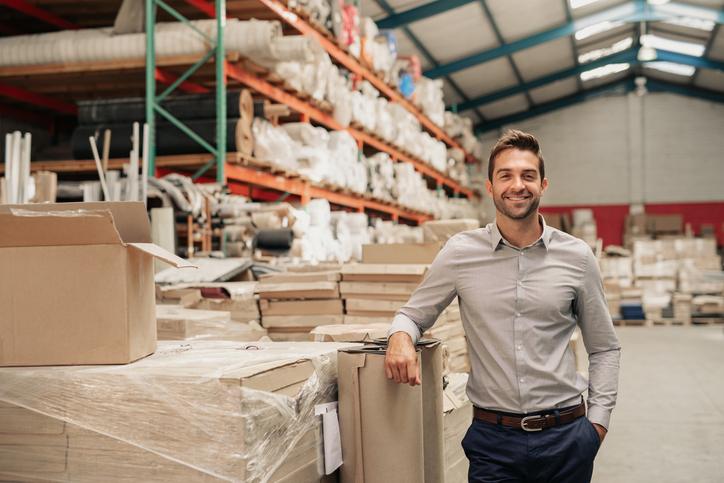 Internal Sales Representative QLD in warehouse standing confidently, representing a sales role specialist.